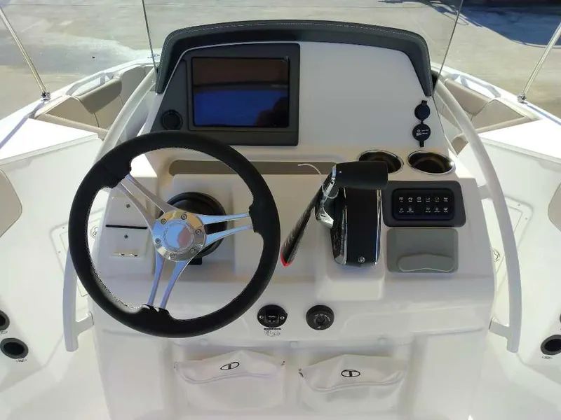 Slide: The Image of 2025 Tahoe 2150 CC boat dashboard with steering wheel and control panel. - 5