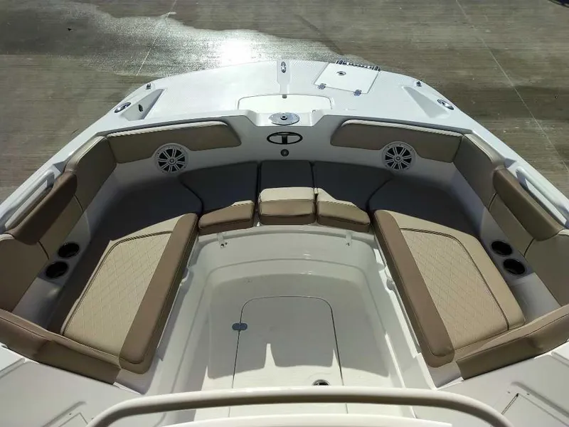 Slide: The Image of 2025 Tahoe 2150 CC boat interior with cushioned seating and speakers. - 6