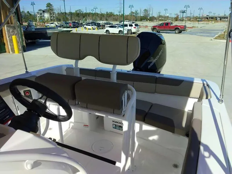 Slide: The Image of 2025 Tahoe 2150 CC boat interior with seating and steering wheel. - 8