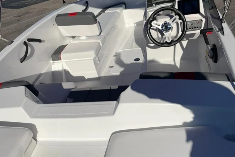 Slide: The Image of 2025 Tahoe T16 boat interior with white seating and modern steering console. - 2