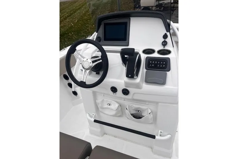 Slide: The Image of 2025 Tahoe 2150 CC boat console with steering wheel, touchscreen, and control panel. - 114