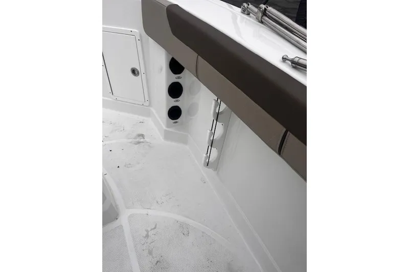 Slide: The Image of 2025 Tahoe 2150 CC boat interior with storage compartments and rod holders. - 115