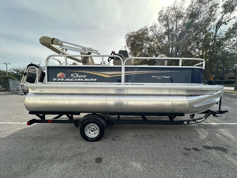 Slide: The Image of 2025 Sun Tracker Bass Buggy 16 XL Select pontoon boat on trailer. - 8