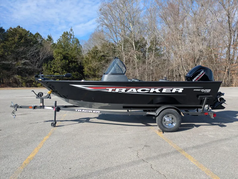 Slide: The Image of 2025 Tracker Pro Guide V-16 WT boat on trailer in parking lot. - 3