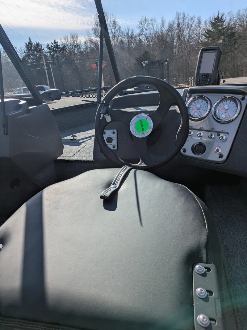 Slide: The Image of 2025 Tracker Pro Guide V-16 WT boat interior with steering wheel and dashboard controls. - 4