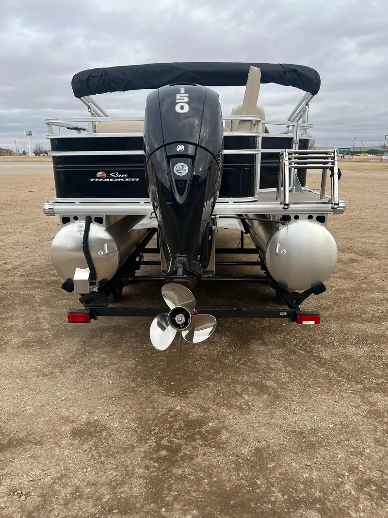 Slide: The Image of 2025 Sun Tracker SportFish 22 DLX pontoon boat, rear view with outboard motor. - 3