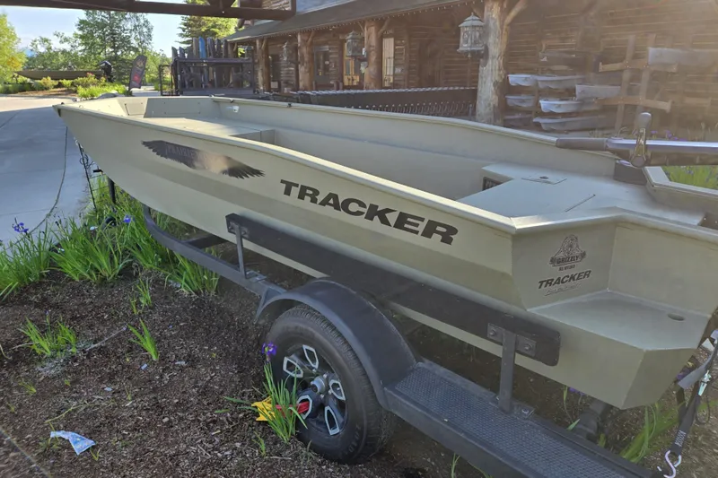 Slide: The Image of 2025 Tracker Grizzly 1650 T Prairie Wings Edition boat on trailer, outdoors. - 2