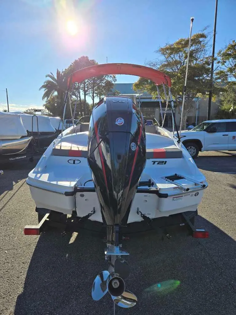 Slide: The Image of 2025 Tahoe T21 boat with outboard motor, parked outdoors under sunny sky. - 5