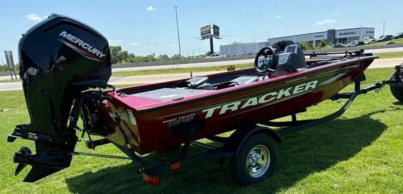 Slide: The Image of 2024 Tracker Pro Team 175 TF boat with Mercury engine on grassy area. - 3