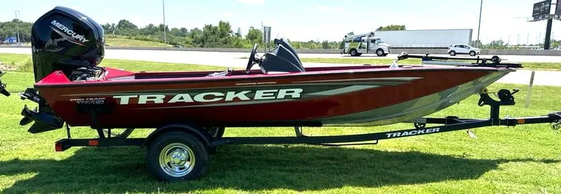 Slide: The Image of 2024 Tracker Pro Team 175 TF boat on trailer, parked on grass. - 4