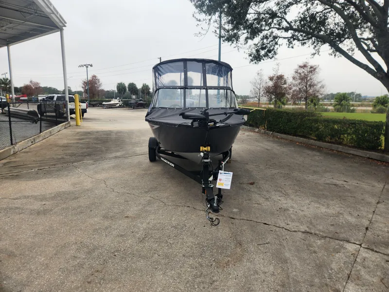 Slide: The Image of 2025 Tracker Pro Guide V-16 WT boat on trailer in outdoor setting. - 2