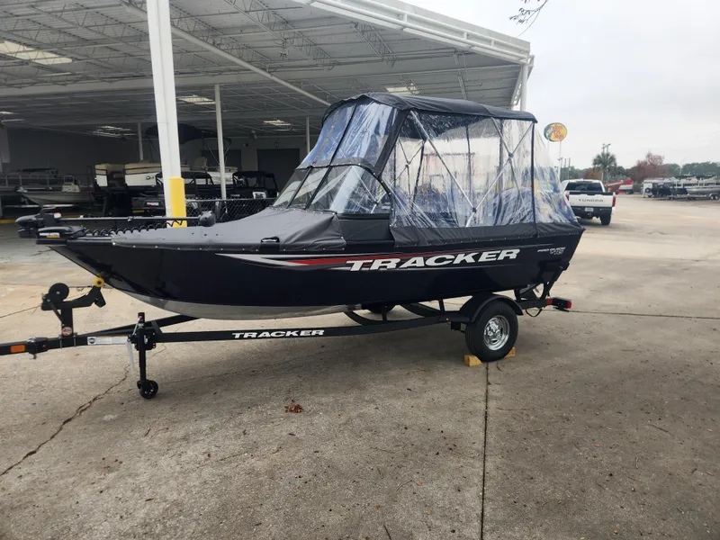 Slide: The Image of 2025 Tracker Pro Guide V-16 WT boat on trailer, parked outdoors. - 3