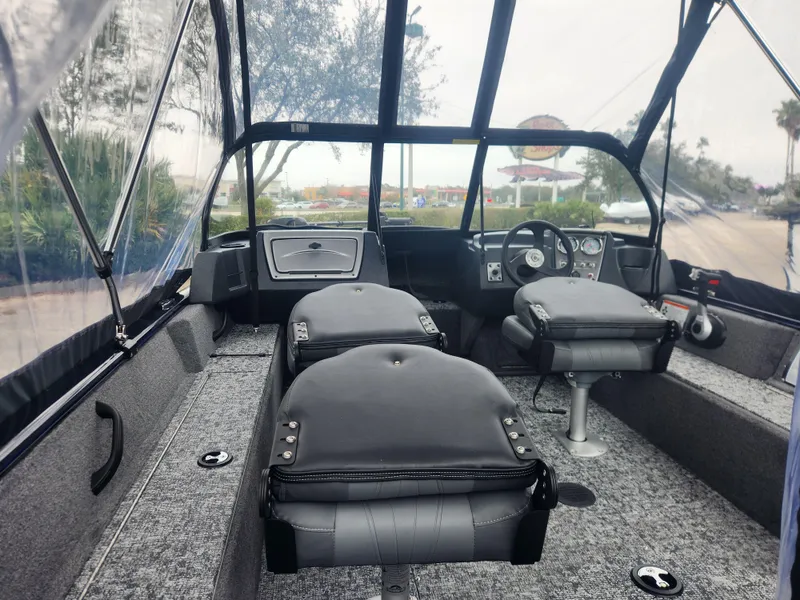Slide: The Image of 2025 Tracker Pro Guide V-16 WT boat interior with seating and steering console. - 4