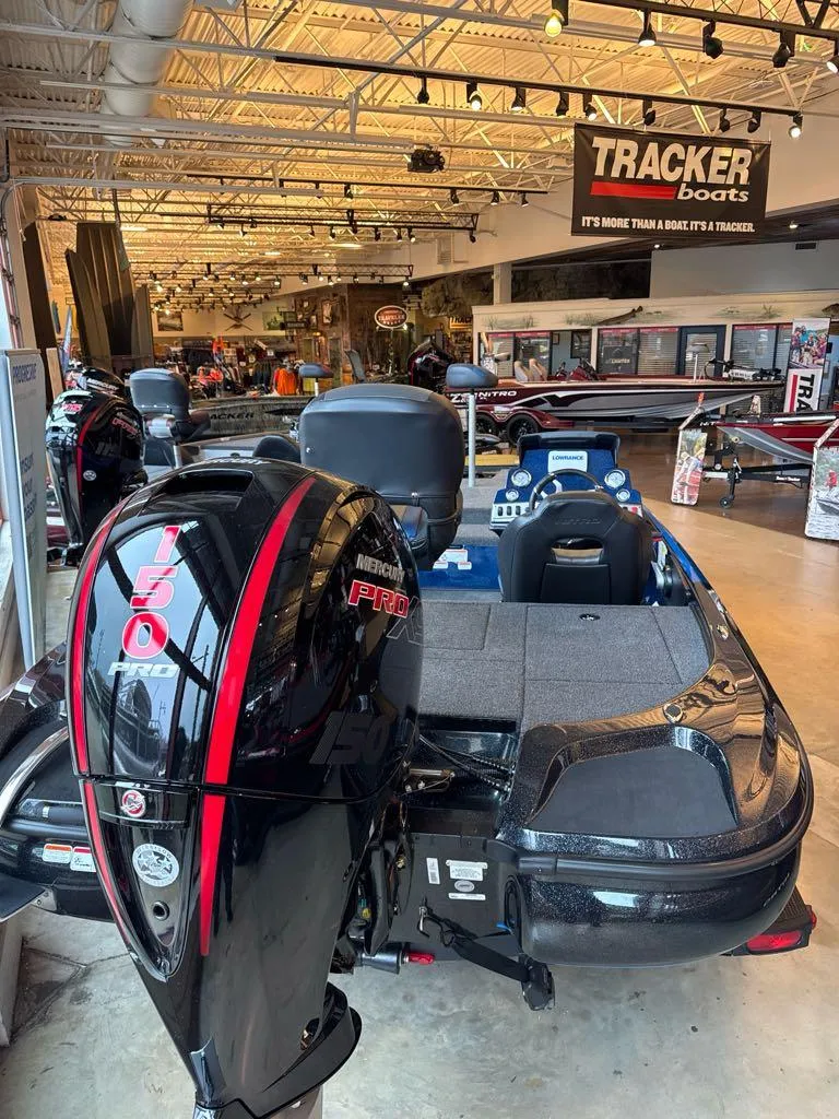 Slide: The Image of 2025 Nitro Z18 boat in showroom with powerful engine, Tracker Boats signage visible. - 3