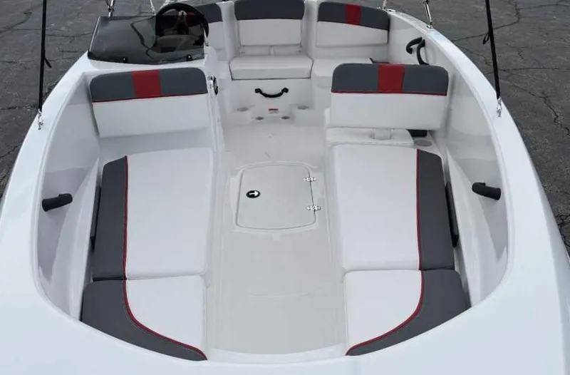 Slide: The Image of 2025 Tahoe T16 boat interior with white and gray seating, red accents, and steering console. - 33