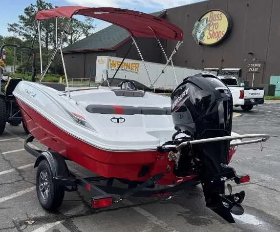 Slide: The Image of 2025 Tahoe T16 boat with red canopy and Mercury outboard motor in parking lot. - 5