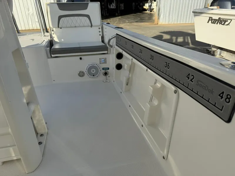 Slide: The Image of 2022 World Cat 235 CC boat interior with seating and measurement scale. - 12