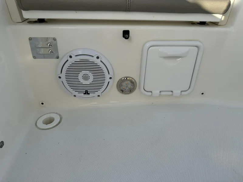 Slide: The Image of 2022 World Cat 235 CC boat interior with speaker and storage compartment. - 13
