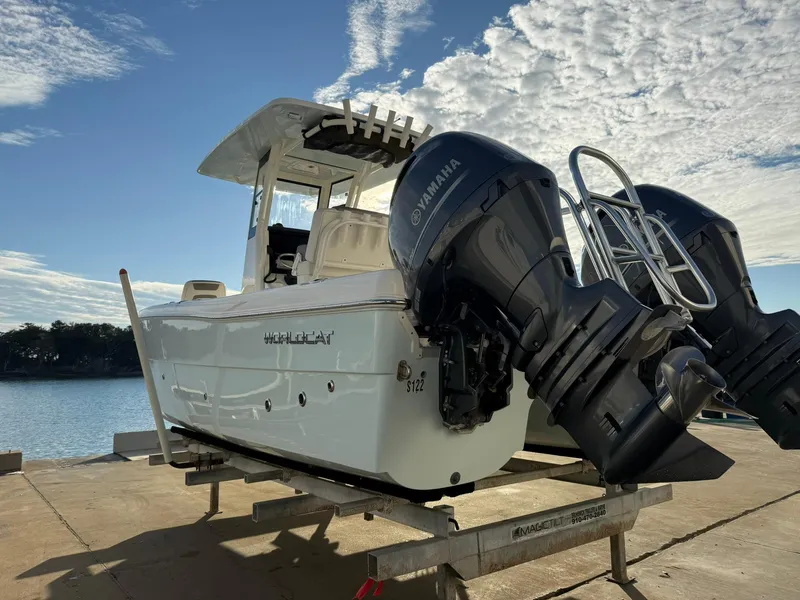 Slide: The Image of 2022 World Cat 235 CC boat with dual Yamaha engines on a trailer by the water. - 14