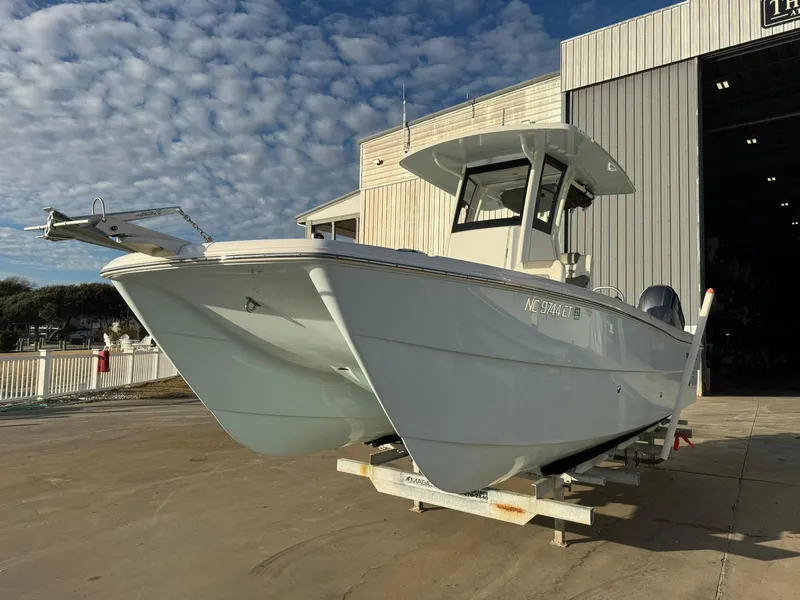 Slide: The Image of 2022 World Cat 235 CC boat on trailer outside a large storage facility. - 15