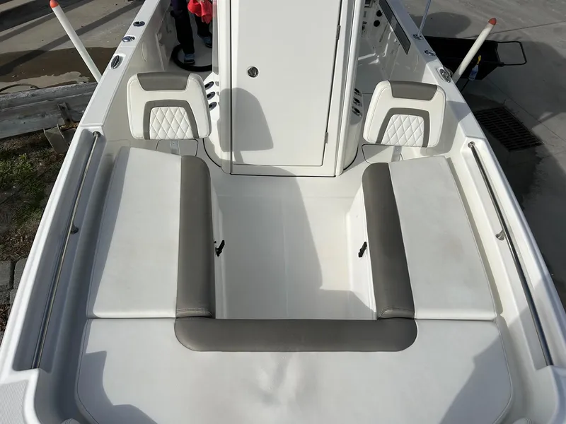 Slide: The Image of 2022 World Cat 235 CC boat interior with cushioned seating and storage compartments. - 17