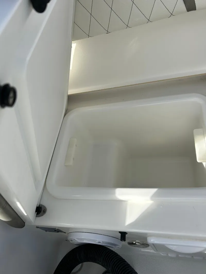 Slide: The Image of 2022 World Cat 235 CC boat storage compartment, open and empty. - 19
