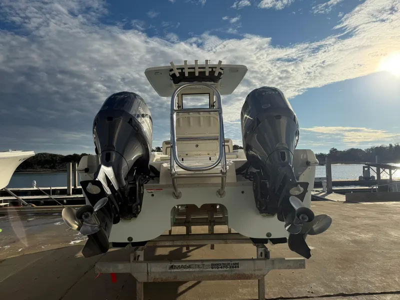 Slide: The Image of 2022 World Cat 235 CC boat with dual engines at a marina dock. - 5