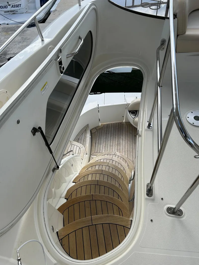 Slide: The Image of 2013 Meridian 441 yacht interior with wooden stairs and sleek design. - 10