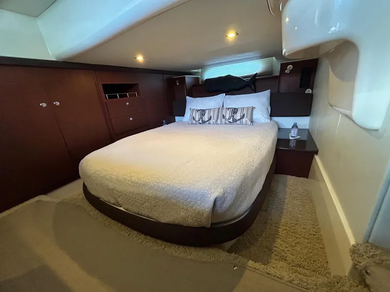 Slide: The Image of Luxurious bedroom interior of 2013 Meridian 441 yacht with cozy bed and elegant wood finish. - 23