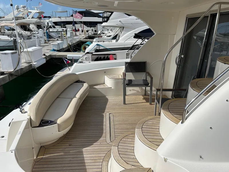 Slide: The Image of Luxurious 2013 Meridian 441 yacht with spacious deck and elegant seating at marina. - 3