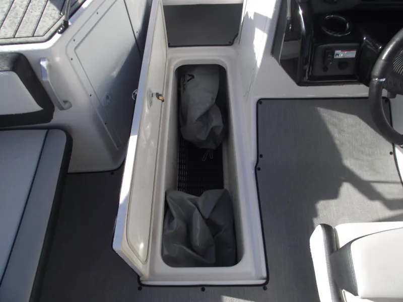 Slide: The Image of 2021 Yamaha AR195 boat interior storage compartment with open lid. - 13
