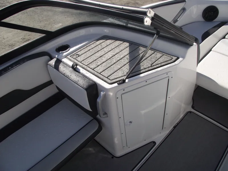 Slide: The Image of 2021 Yamaha Boats AR195 interior with sleek seating and storage compartment. - 14