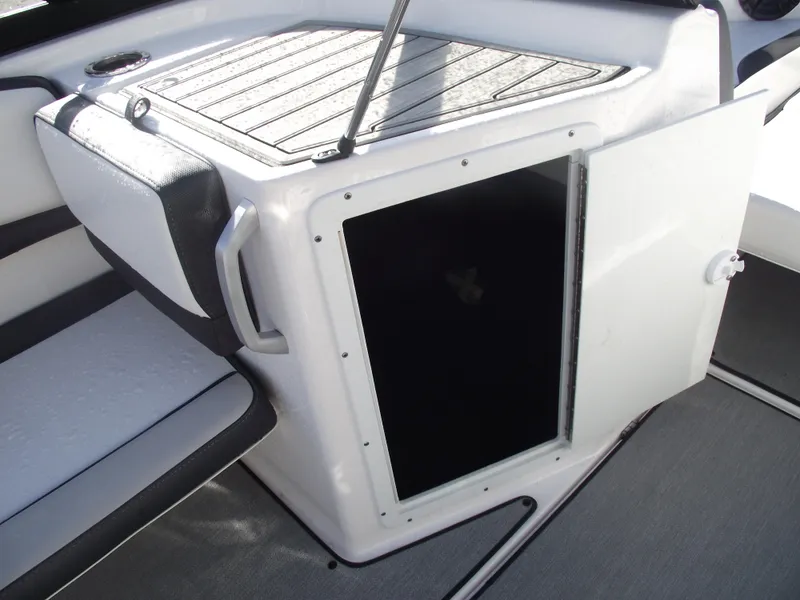 Slide: The Image of 2021 Yamaha AR195 boat interior storage compartment with open door. - 15