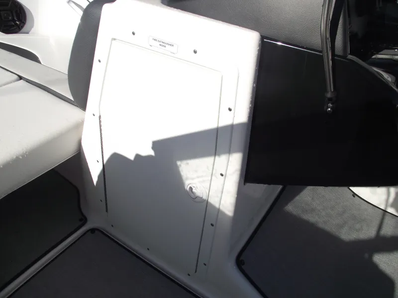 Slide: The Image of 2021 Yamaha AR195 boat interior with storage compartment and seating area. - 16