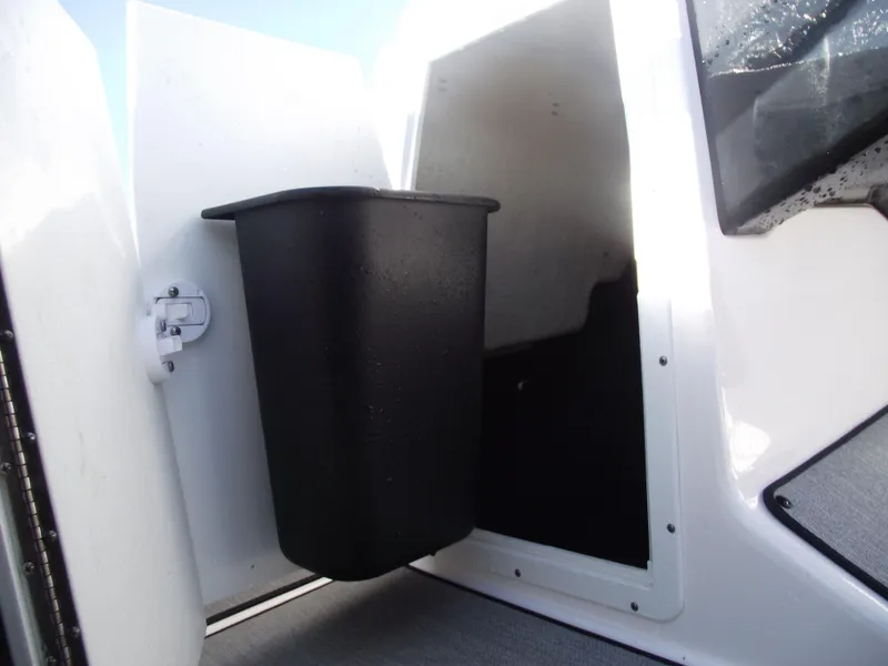 Slide: The Image of 2021 Yamaha AR195 boat storage compartment with black bin. - 17