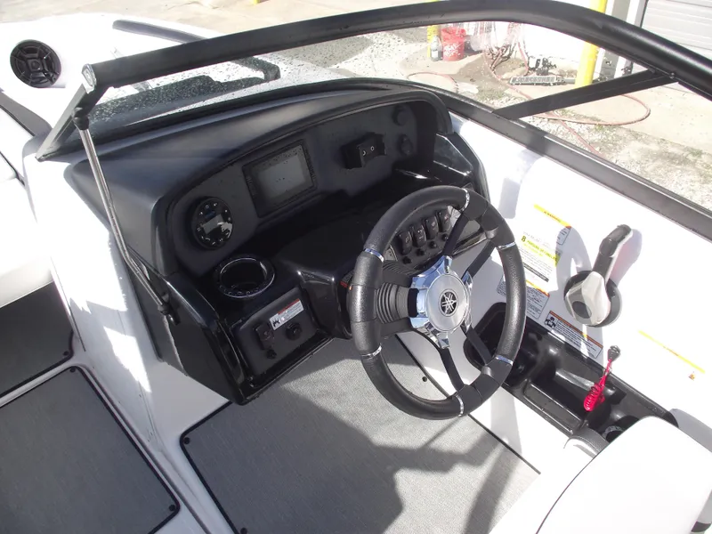Slide: The Image of 2021 Yamaha Boats AR195 dashboard with steering wheel and controls. - 18