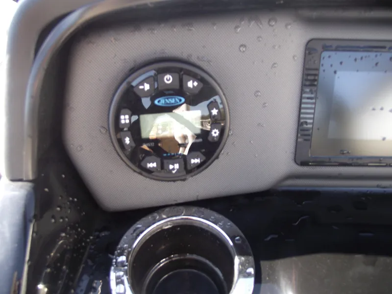 Slide: The Image of Close-up of 2021 Yamaha AR195 boat dashboard with control panel and cup holder. - 19