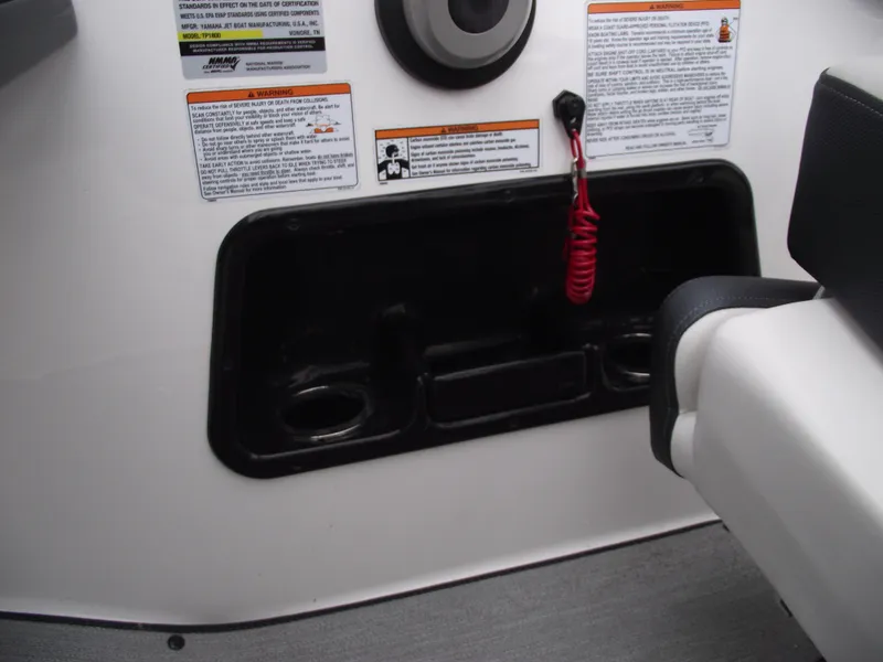 Slide: The Image of Interior of 2021 Yamaha AR195 boat with safety instructions and storage compartment. - 21
