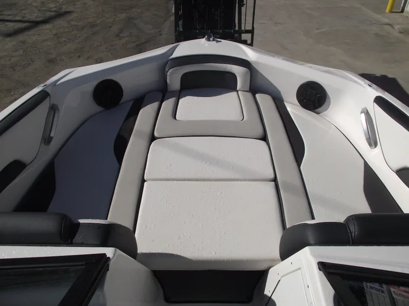 Slide: The Image of 2021 Yamaha AR195 boat interior with cushioned seating and speakers. - 4
