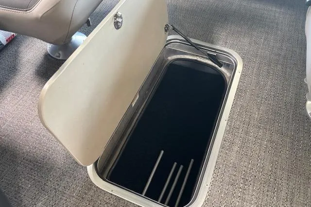 Slide: The Image of Open storage compartment on 2025 Barletta A22UC boat with carpeted flooring. - 10