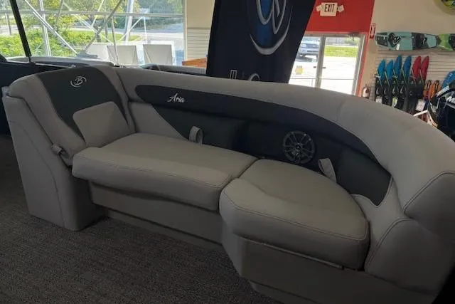 Slide: The Image of 2025 Barletta A22UC boat interior with luxurious gray seating in showroom. - 7