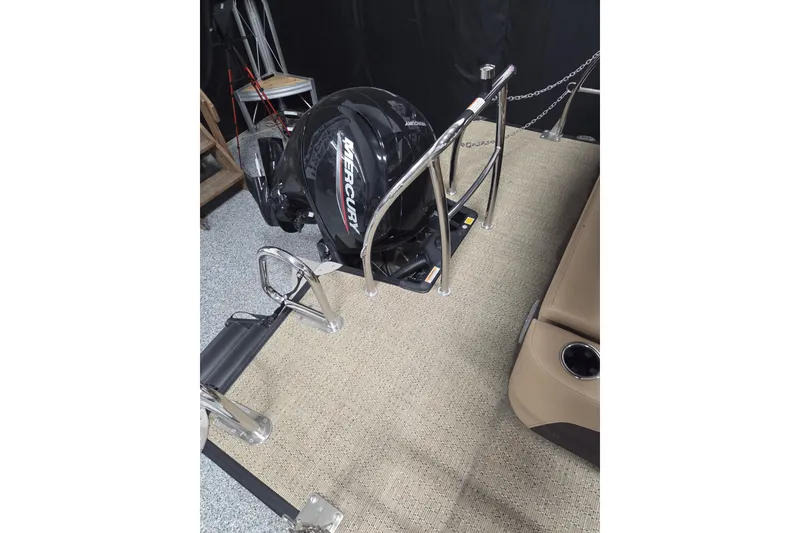 Slide: The Image of 2025 Barletta Cabrio 24U boat helm with steering wheel and Simrad display. - 11