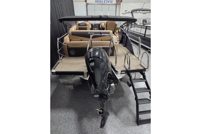 Slide: The Image of 2025 Barletta Cabrio 24U boat interior with beige seating and cup holders. - 12