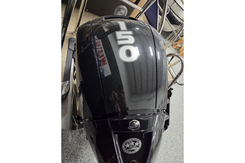 Slide: The Image of 2025 Barletta Cabrio 24U boat with Mercury outboard motor and stainless steel railings. - 13