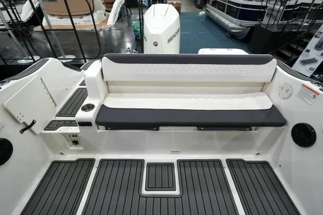 Slide: The Image of 2025 Bayliner T22SC boat interior with cushioned seating and modern design. - 12