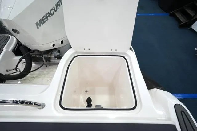 Slide: The Image of 2025 Bayliner T22SC boat storage compartment with Mercury engine in background. - 14