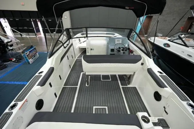 Slide: The Image of 2025 Bayliner T22SC boat interior with seating and steering console. - 5