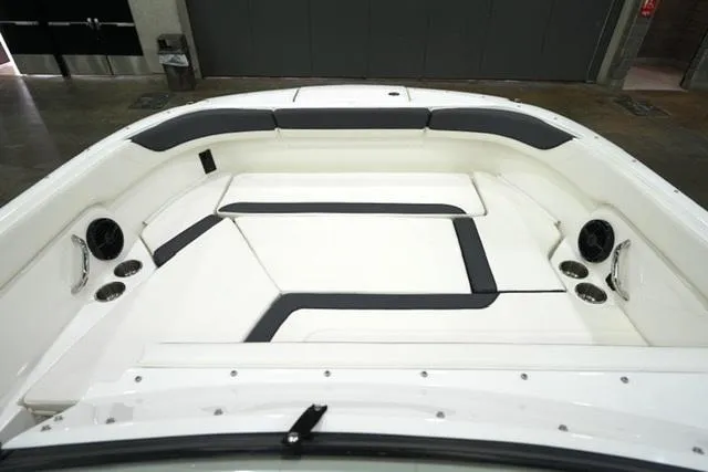 Slide: The Image of 2025 Bayliner T22SC boat interior with cushioned seating and cup holders. - 6