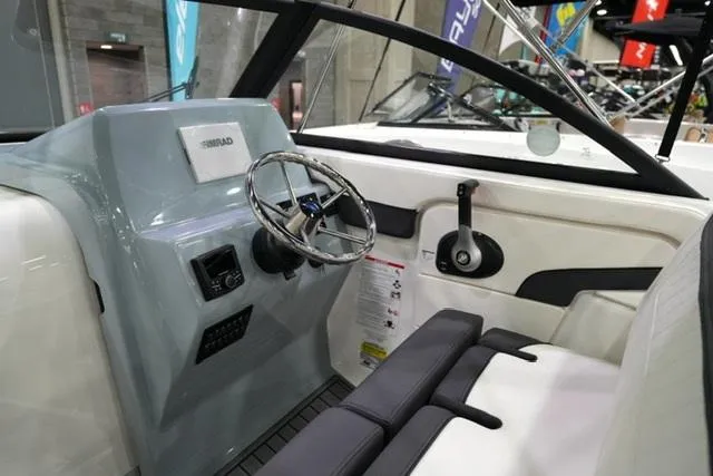 Slide: The Image of 2025 Bayliner T22SC boat interior with steering wheel and control panel. - 8