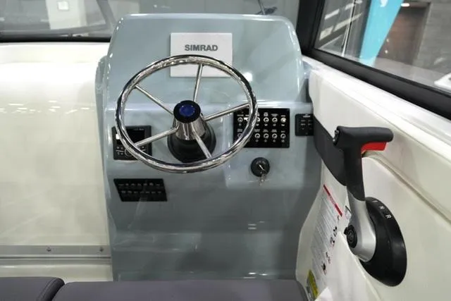 Slide: The Image of 2025 Bayliner T22SC helm with Simrad display and steering wheel. - 9